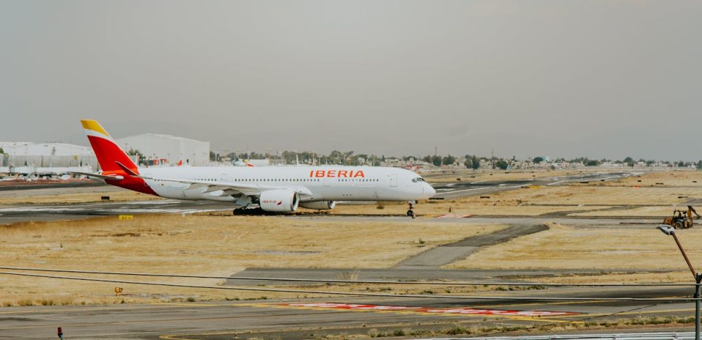 Iberia airplane on runway at airport, ready for international travel.